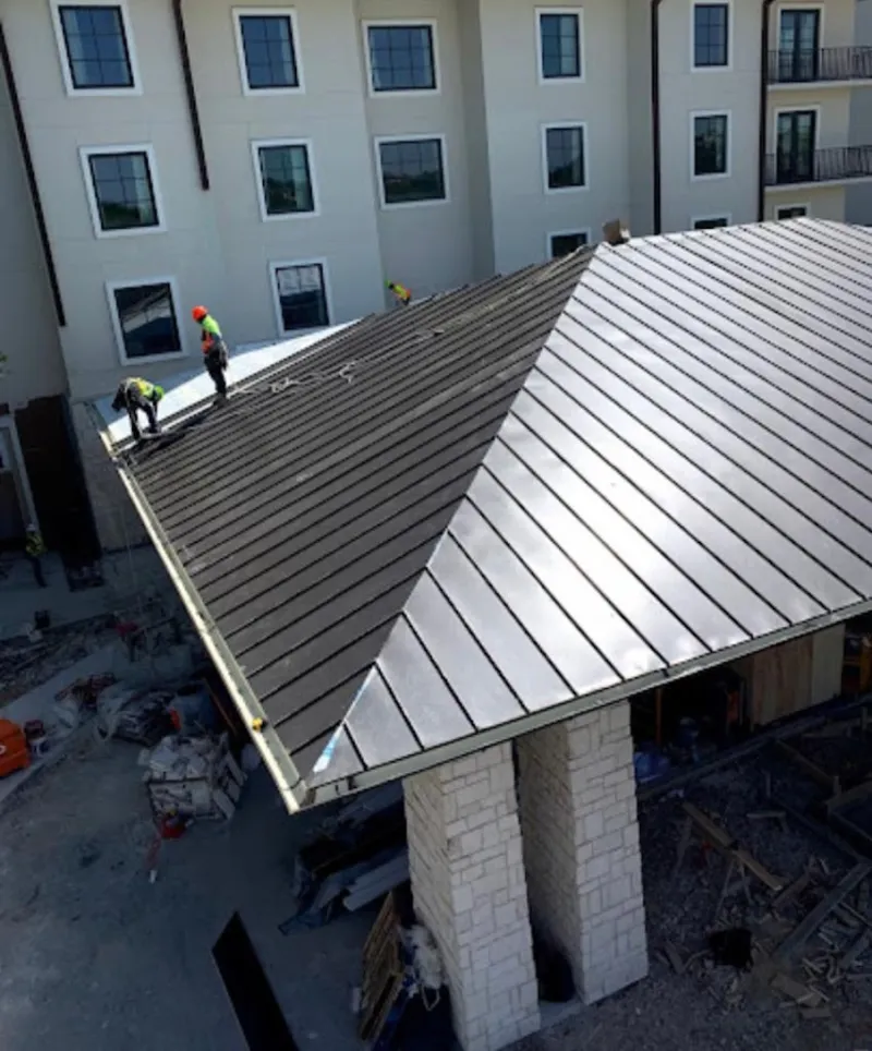 Crew installing standing seam metal roof panels on a commercial project in El Paso de Robles (Paso Robles)